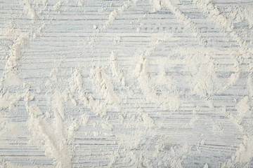 Scattered flour on light wooden background