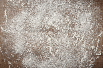 Scattered flour on wooden background
