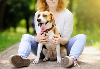 Young beautiful woman with Beagle dog