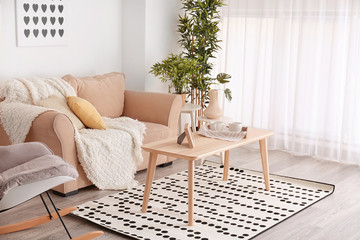 Elegant living room interior with comfortable sofa and table