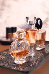 Obraz na płótnie Canvas Tray with perfume bottles on table