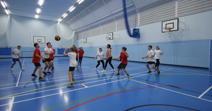 4k, School basketball team playing a game indoors.