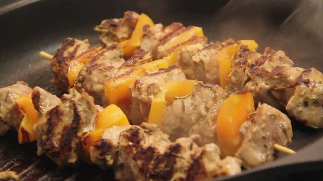 Pork skewer kebab on stove top grill footage no audio