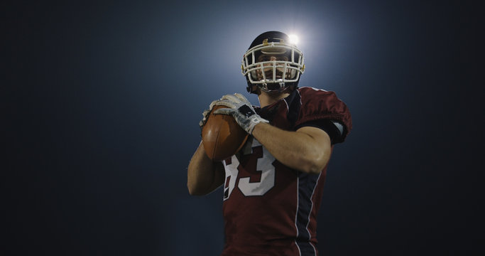 american football player throwing rugby ball