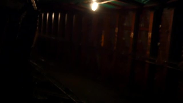 Looking behind us as we ride down a long coal mine shaft in a cart in Pennsylvania Rust Belt