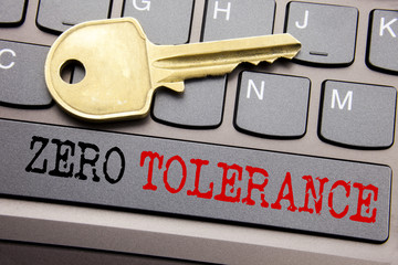 Hand writing text caption inspiration showing Zero Tolerance. Business concept for Policy For Punishment written on keyboard key on the with key next to the text.