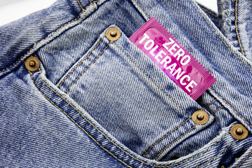 Handwriting Announcement text showing Zero Tolerance. Business concept for Policy For Punishment Written on condom pack put in the small pocket to pants jeans.