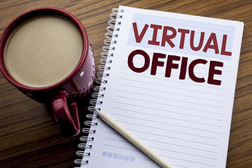 Hand writing text caption inspiration showing Virtual Office. Business concept for Online Way Of Working written on note paper notepad book on the wooden background with coffee and pen.