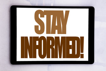 Hand writing text caption inspiration showing Stay Informed. Business concept for Be Awareness Or Awake written on tablet screen on the white background.