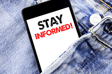 Hand writing text caption inspiration showing Stay Informed. Business concept for Be Awareness Or...