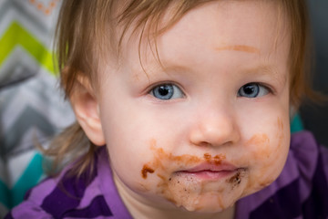 A sweet girl with chocolate on her face