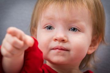 A toddler pointing at something