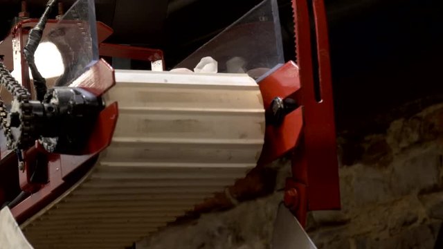 freshly made saltwater taffy falls off a conveyor belt at a confectionery store in savannah, georgia