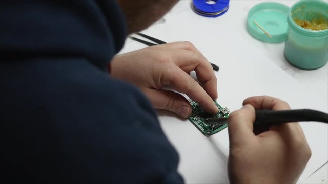 electronic engineer soldering circuit perfboard