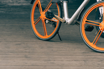 closeup of a shared bicycle parked on sidewalk.