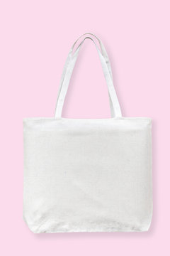Tote bag canvas white cotton fabric cloth for eco shoulder shopping sack mockup blank template isolated on pastel pink background (clipping path)