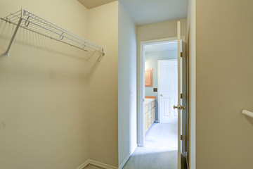 Empty closet interior with wall mounted shelves