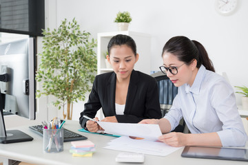 women working together talking project