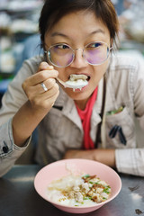 Asian woman eating crepe congree