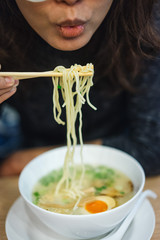Woman eating noodle in restuarant