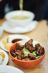 Fried pork teriyaki in orange bowl