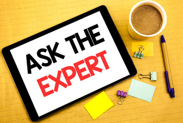 Conceptual hand writing text caption showing Ask The Expert. Business concept for Advice Help Question Written on tablet laptop, wooden background with sticky note, coffee and pen