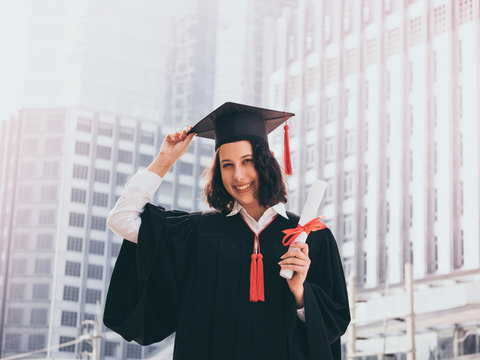 Graduation day, Young woman with graduation cap and gown holding diploma, Successful concept