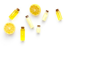 Natural organic cosmetics with lemon. Lemon oil or lotion, spa salt in small bottles on white background top view copy space