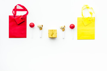 Gift concept. Sweets, paper bag for gift on white background top view copy space