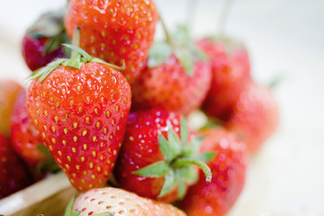 Close up of fresh strawberry in wooden dish