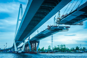 Construction of a bridge across the river. The long bridge. Metal structures. High bridge. Highway...