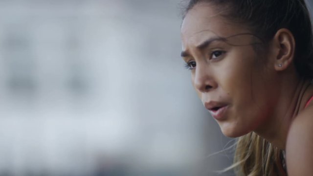 Healthy young female getting her breath back after  a workout, in slow motion