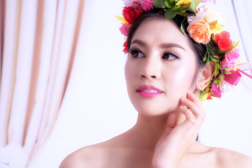 Closeup portrait of beautiful woman with flowers, Face makeup and Hairstyle.