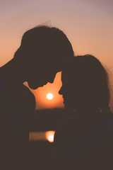silhouette couple lover in romantic of fascinate on the beach at sunset