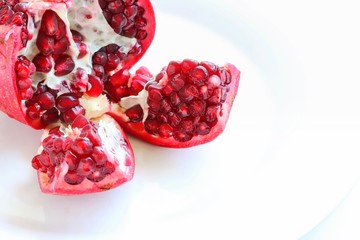 Fresh Juicy Pomegranate on White Plate
