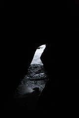 Light coming in one small opening of an ocean cave