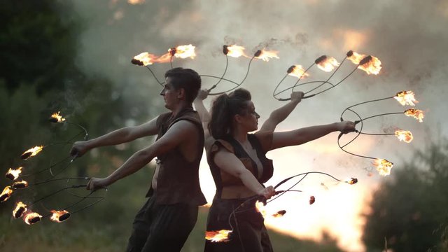 Artists rotating with fire staffs