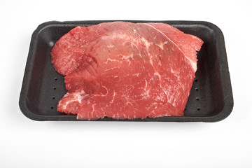 fresh raw beef in a package isolated on white background