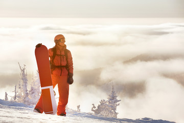Snowboarding concept with man and snowboard against mountain top