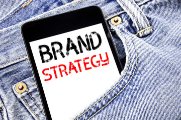 Handwriting Announcement text showing Brand Strategy. Business concept for Marketing Idea Plan Written phone mobile phone, cellphone placed in the man front jeans pocket.