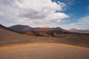 Fototapeta na wymiar Amazing volcanic landscape and lava desert in Timanfaya national park, Lanzarote, canary islands, Spain.