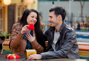 Young man giving a gift as to a young girl
