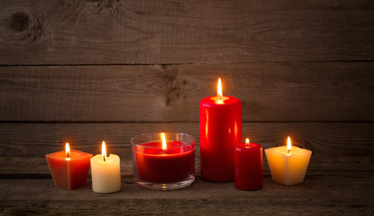 red and white candles on dark wooden background