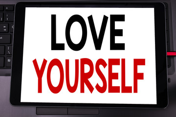 Conceptual hand writing text caption inspiration showing Love Yourself. Business concept for Positive Slogan For You written on tablet laptop on the black keyboard background.