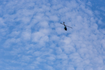 helicopter flying against blue sky