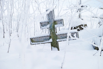 rickety cross at the abandoned grave at the old believers cemetery