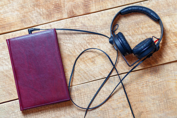 Headphones with a book, concept the audiobook