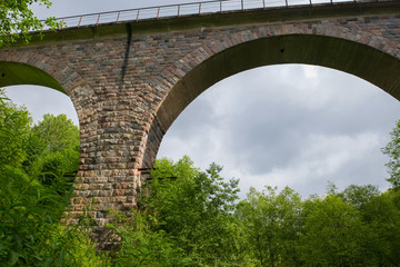 Fototapeta na wymiar Viaduct across the river Yaryngya. Krestetsky District, Novgorod Region Russia