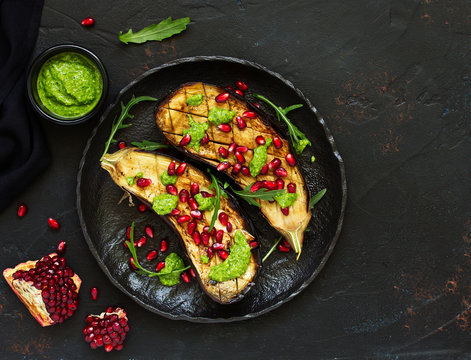 Baked grilled aubergines with pesto and pomegranate sauce.