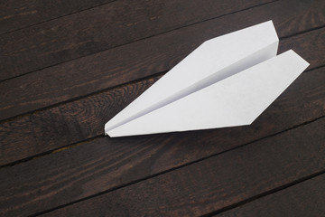 Paper airplane on wood